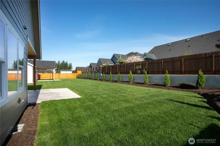 The backyard is level and the back fence is taller than normal due to the retaining wall.  The additional height lends for more privacy.