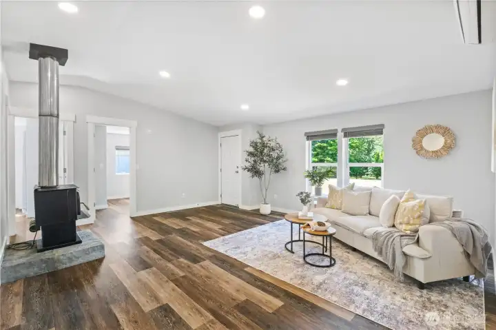 Large living room with natural and can lights.