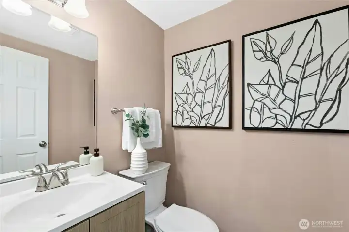 Guest bath, hall bath, call it what you'd like. A convenient half bath on the main floor. New vanity, flooring, and lighting. Guest bath, hall bath, call it what you'd like. A convenient half bath on the main floor. New vanity, flooring, and lighting.