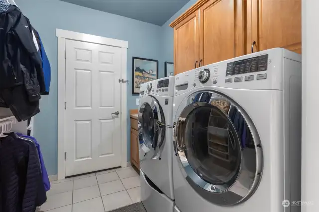 Your laundry room is fully equipped with a utility sink, upper storage cabinets and a custom closet system meticulously designed for optimal organization. Included is a front-loading washer & dryer set complemented by convenient storage pedestals, ensuring efficiency and convenience for all your laundry needs.