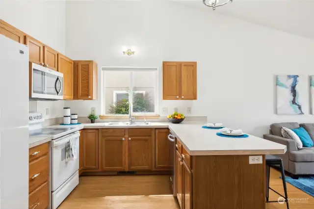 The kitchen features a new dishwasher, new microwave and new kitchen faucet, plus all appliances stay!