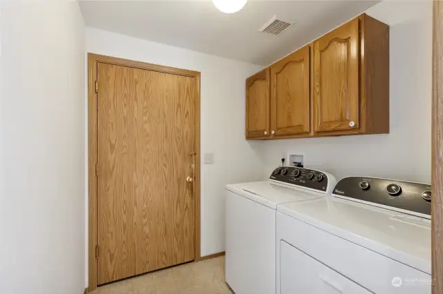 The washer and dryer stay with the home, and this laundry room has cabinet storage and easy access to the 2-car garage, acting as a nice mud room when entering from the garage.