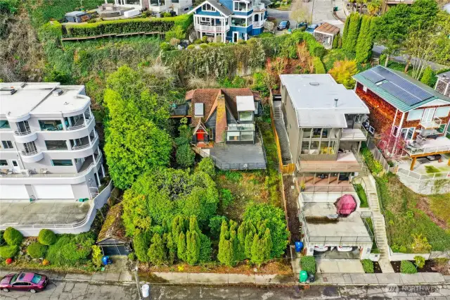 Subject property aerial in center  of treed lot
