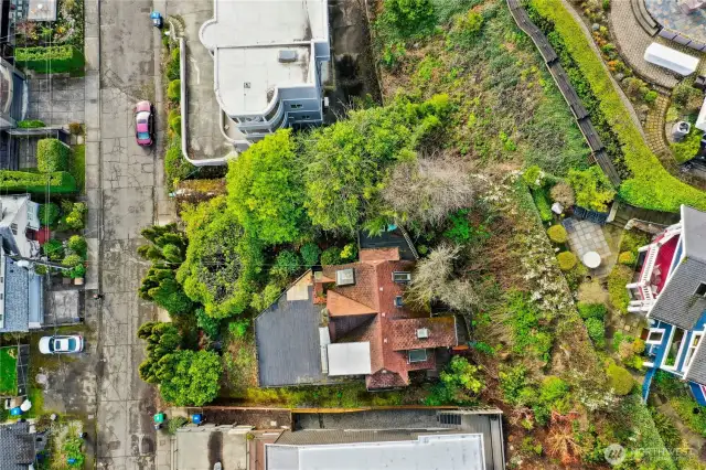 Aerial of house on lot w/home to the west behind subject property