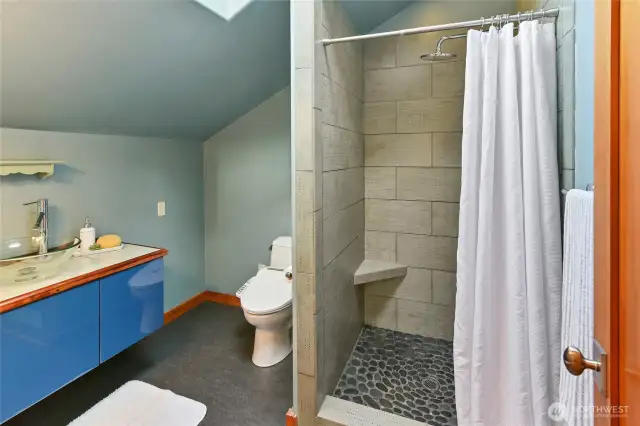Master bathroom upstairs with walk-in shower and custom tile work.