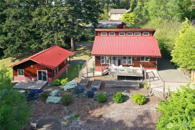 The back yard is zero maintenance now and a blank slate for grass or more gardens. Mature plantings require almost no effort, yet the option to expand is left to your imagination.