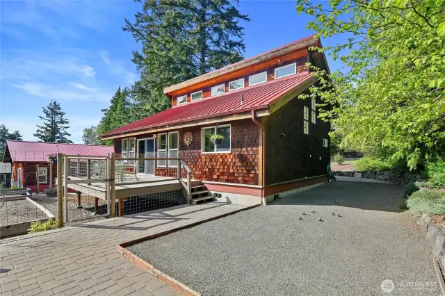 The side of the home has a terrific paver patio set up in front of what the current owners use as a regulation P'etanque court! Lots of out of the way outdoor storage.