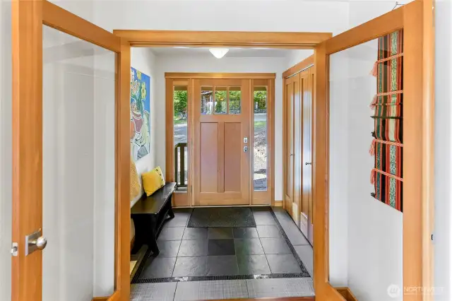 Douglas fir trim, solid doors and custom tilework in the mudroom entryway.