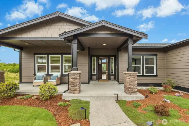 Beautiful covered entry leads to a spacious covered porch