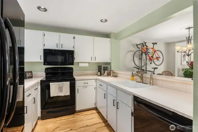 This well-equipped kitchen features updated appliances, ample cabinetry, and generous countertop space for cooking and entertaining with ease.