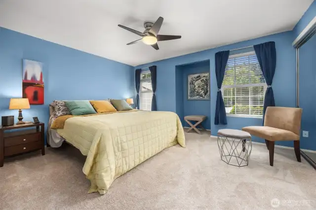 The spacious primary bedroom fits a king-sized bed comfortably, with room for side tables, dressers, and more.