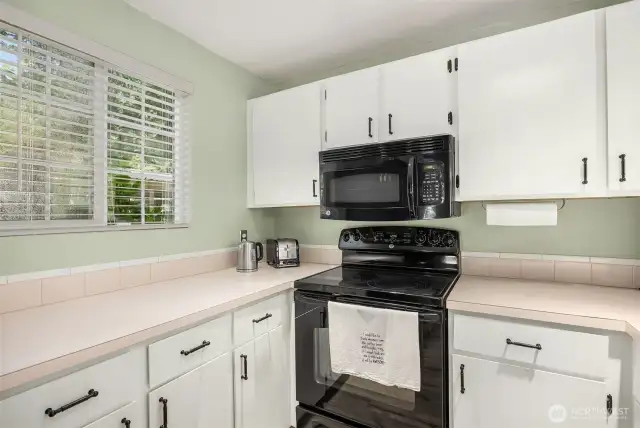 Bright lighting overhead makes every task easier, from chopping vegetables to reading recipes and managing dinner prep.