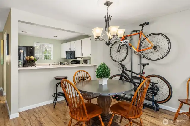 The dining area is nestled between the kitchen and living room, offering a cozy, functional space for family meals or casual gatherings.