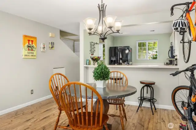 A stylish overhead light fixture defines the dining zone while adding character and warmth to the space.