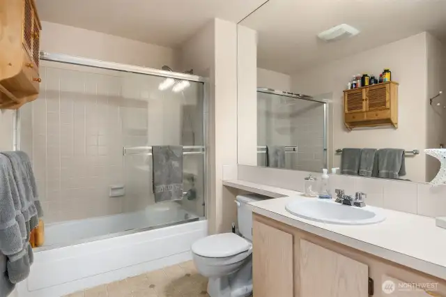 The main full bathroom includes a shower/tub combo with clean tilework and modern fixtures for comfort and ease.
