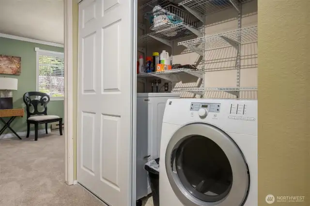 The laundry space is discreetly tucked away in a hallway closet or separate room for a clean, uncluttered feel.