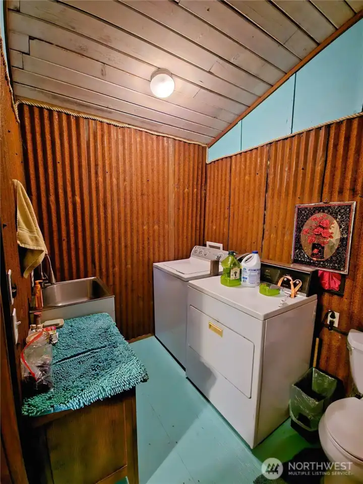 This laundry / second bath could easily make a full primary bath. Metal is decorative and can be removed.
