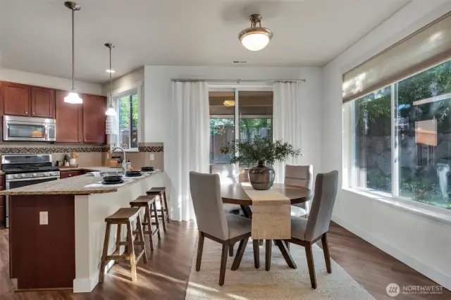 The dining area sits off the kitchen overlooking the backyard.