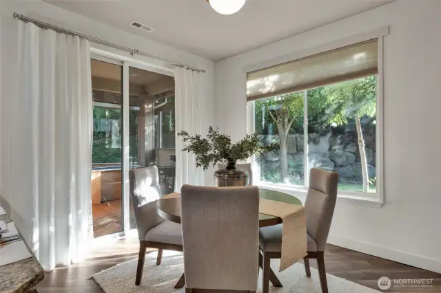 Slider door steps out to a sunroom maximizing your entertainment space.