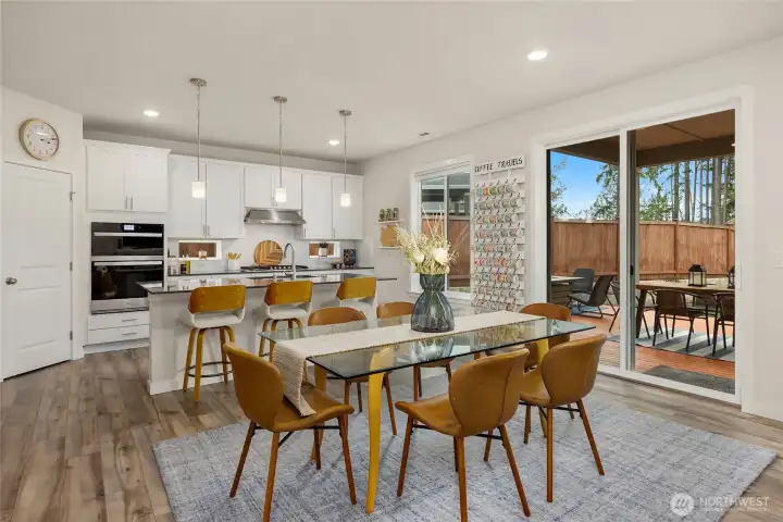 The home features an open concept kitchen, dining and living room for easy flow . This dining space looks out towards the back yard.