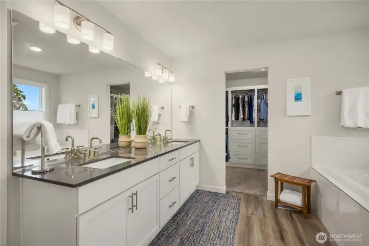 Primary bathroom features Quartz counters and undermount sinks and beautiful lighting and fixtures.