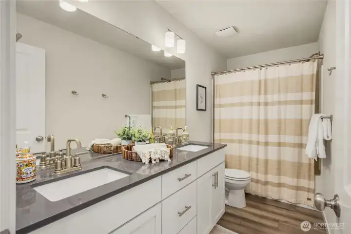 The upstairs bath echoes the primary bathroom with luxury amenities.