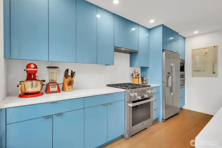 Great stainless appliances with gas cooking for the culinary inclined. What pop of color these cabinets make!