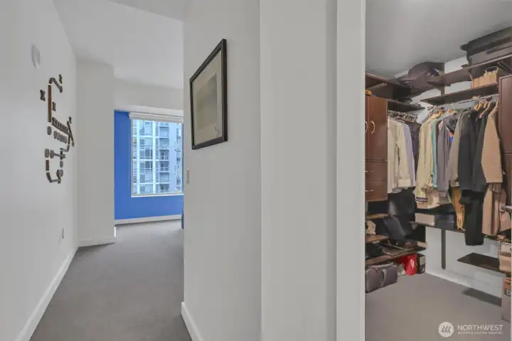 From the hall looking into the primary bedroom to see the walk in closet. The organizers really make it efficient!