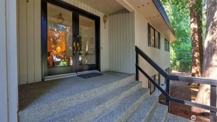 Welcoming entry framed by double glass doors, offering a first glimpse into the inviting living space beyond.