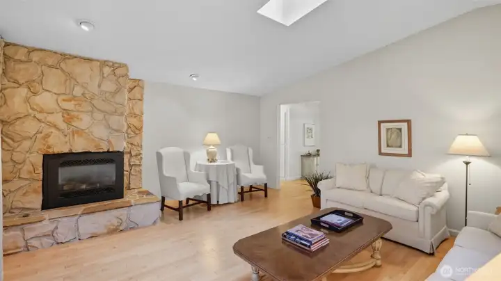 Charming stone fireplace brings warmth and character to this inviting living area.