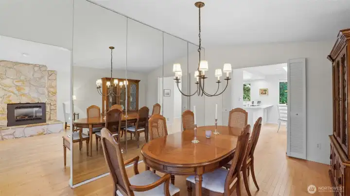 This elegant dining space with mirrored wall accents offers seamless flow into the living room
