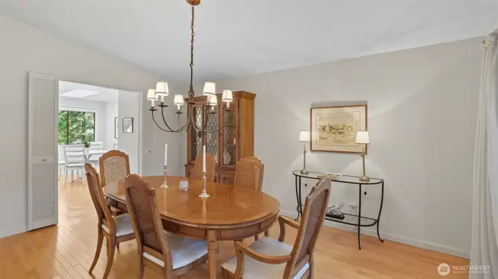Spacious formal dining room designed for hosting, enhanced by warm wood tones and statement lighting.