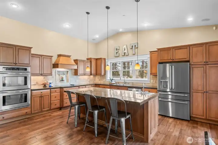 he warm, functional open-concept kitchen invites friends and family to gather around and join in the process.