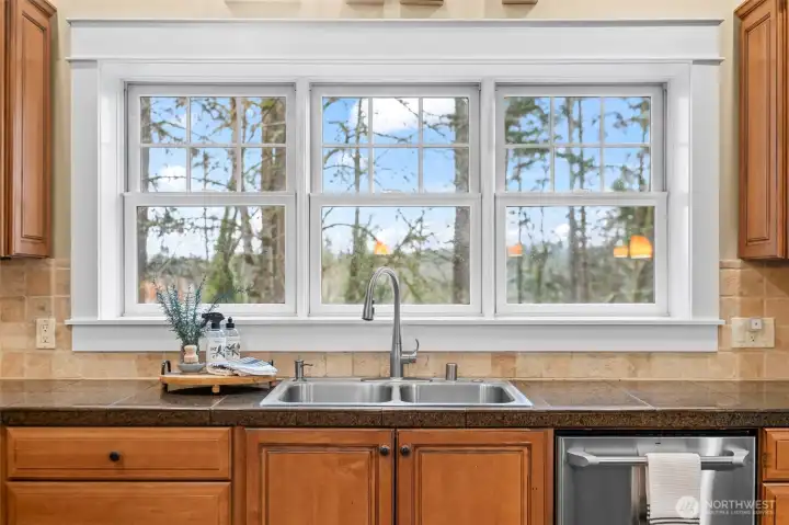 Wide windows bring the beauty of the natural surroundings into the space.