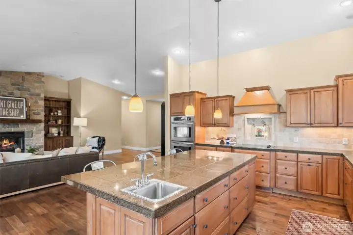 The large island flowing into the living room is the perfect spot for casual meals or gathering with friends.