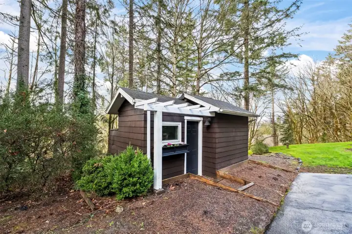 The detached potting shed and wellhouse are just steps from the front door.