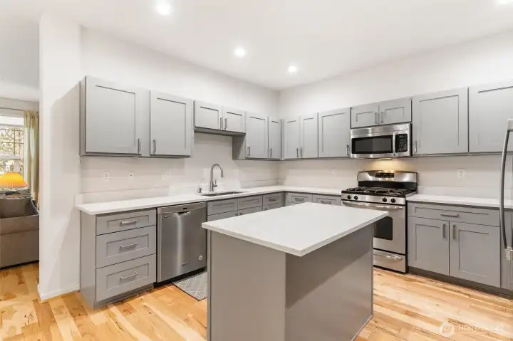 Updated kitchen with quartz countertops, designer cabinetry and stainless steel appliances