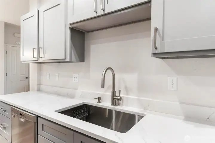 Deep undermounted sink and designer faucet