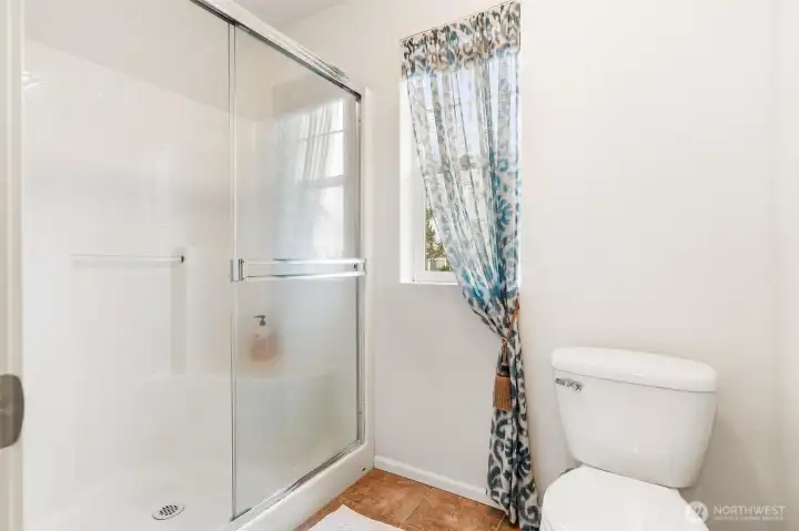 Shower and toilet in primary bathroom