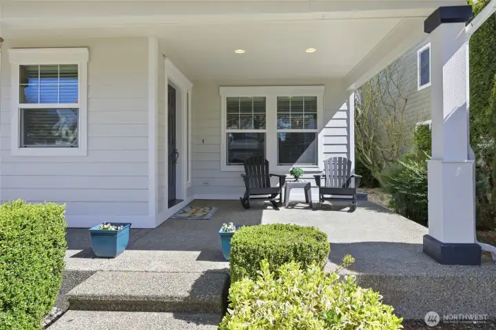 Welcoming aggregate front porch with room to relax and enjoy the outdoors all year.