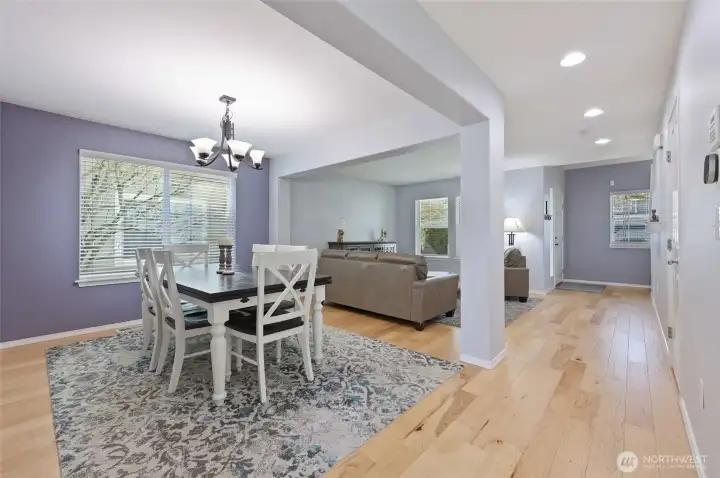 Recessed lighting and light wood floors draw you in to the front living room and dining area.
