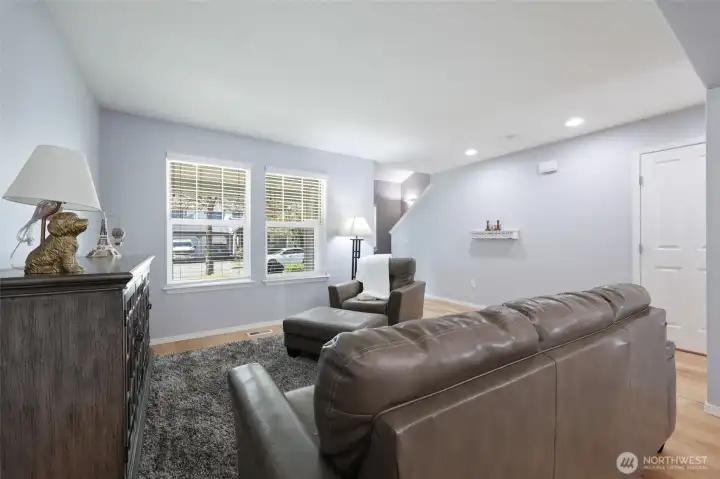 Door on the right is the convenient 1/2 bath; staircase to upper level is seen center photo.