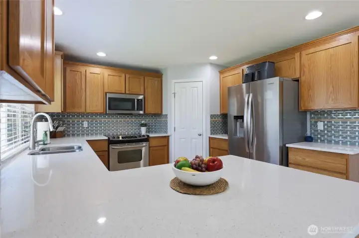 Walk-in-pantry, undermount sink, and loads of smooth counterspace make this a dreamy place to cook!