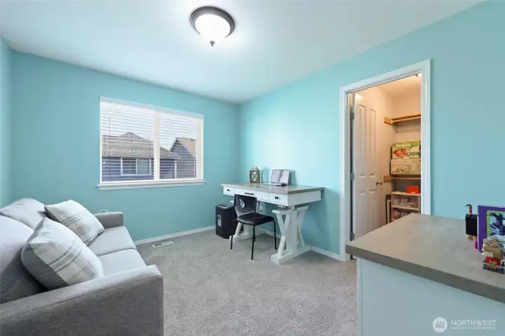 Currently used as a home office, this room boasts a walk-in closet!