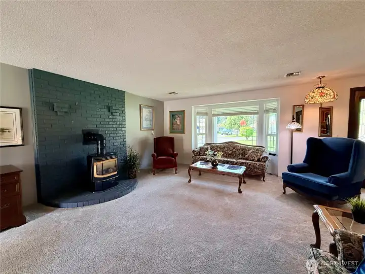 Another view of the living room, with a fireplace that can be fully functional once serviced.