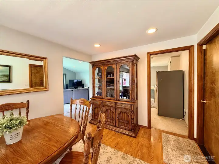 Dining area next to a French door on the left to the patio. The door on the right is the garage, beyond is the utility room and a room on the left is the family room.