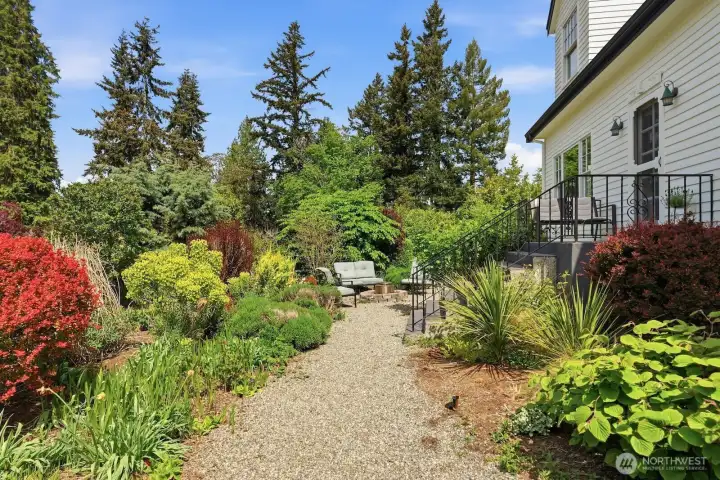 Lush mature plantings, native varieties, and pollinator gardens greet you from the moment you walk up.