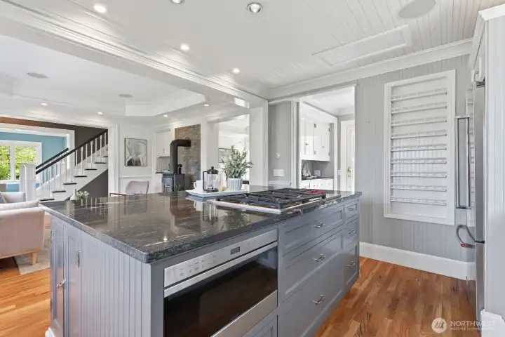 The center island is the perfect spot for morning coffee or to watch the chef at work.