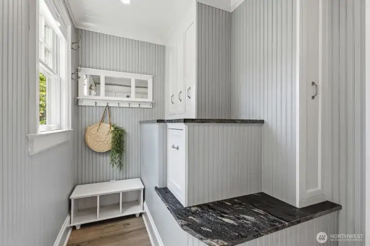 This mudroom area off of the kitchen has a door leading out to the garage and backyard - perfect for muddy boots and rain jackets during wet PNW winters.