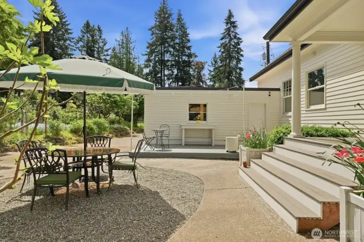 Life extends outdoors with ease thanks to multiple outdoor living spaces for you to enjoy, like this sun-drenched patio!